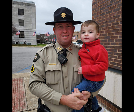 Matt Roberts holding his son