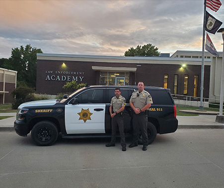 Matt Roberts and Corporal Bruno at the MSHP Training Academy in front of a HCSO Patrol Car