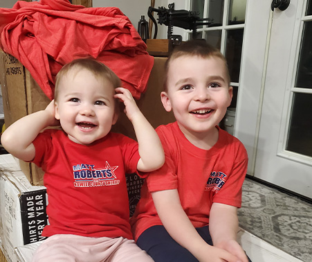 Two children wearing Matt Roberts t-shirts