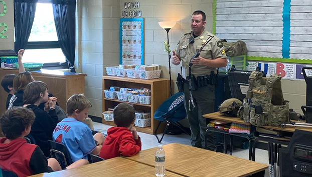 Matt Roberts speaking to a classroom of elementary school-age children.