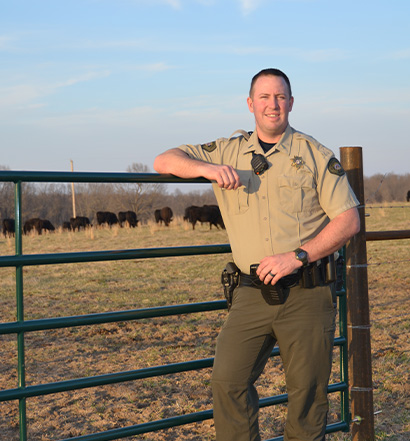 Matt Roberts standing in front of a fence